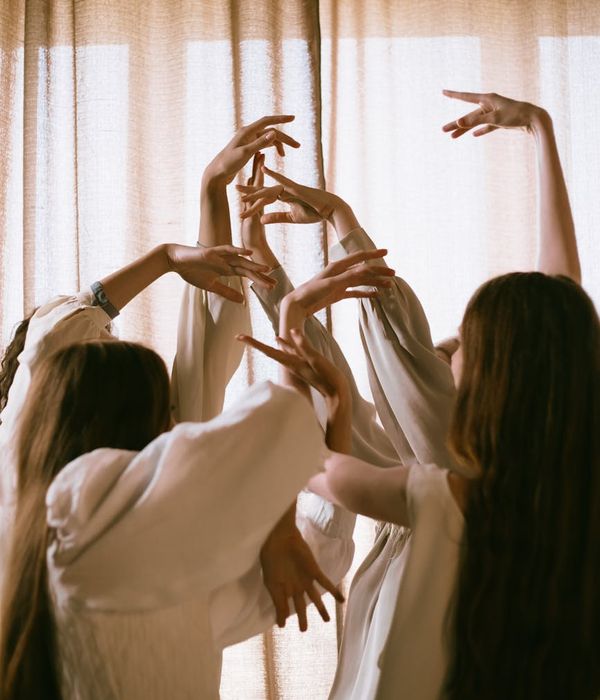 Woman in a calm, flowing pose against a cream background, representing gentle movement.